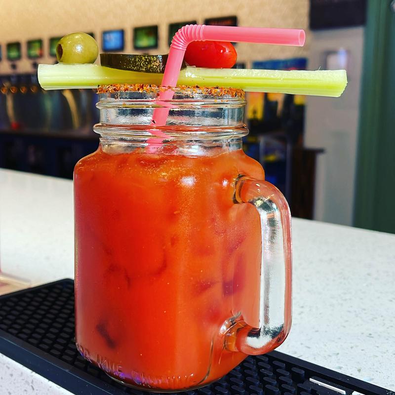 Bloody Mary served in a garnished glass jar