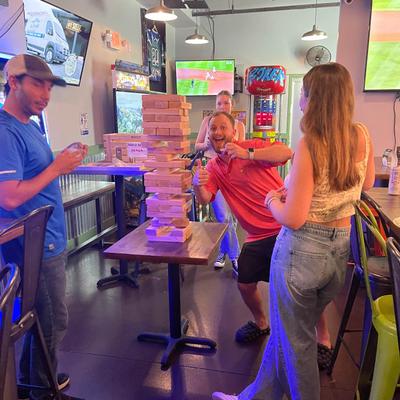 Inside, people playing Jenga